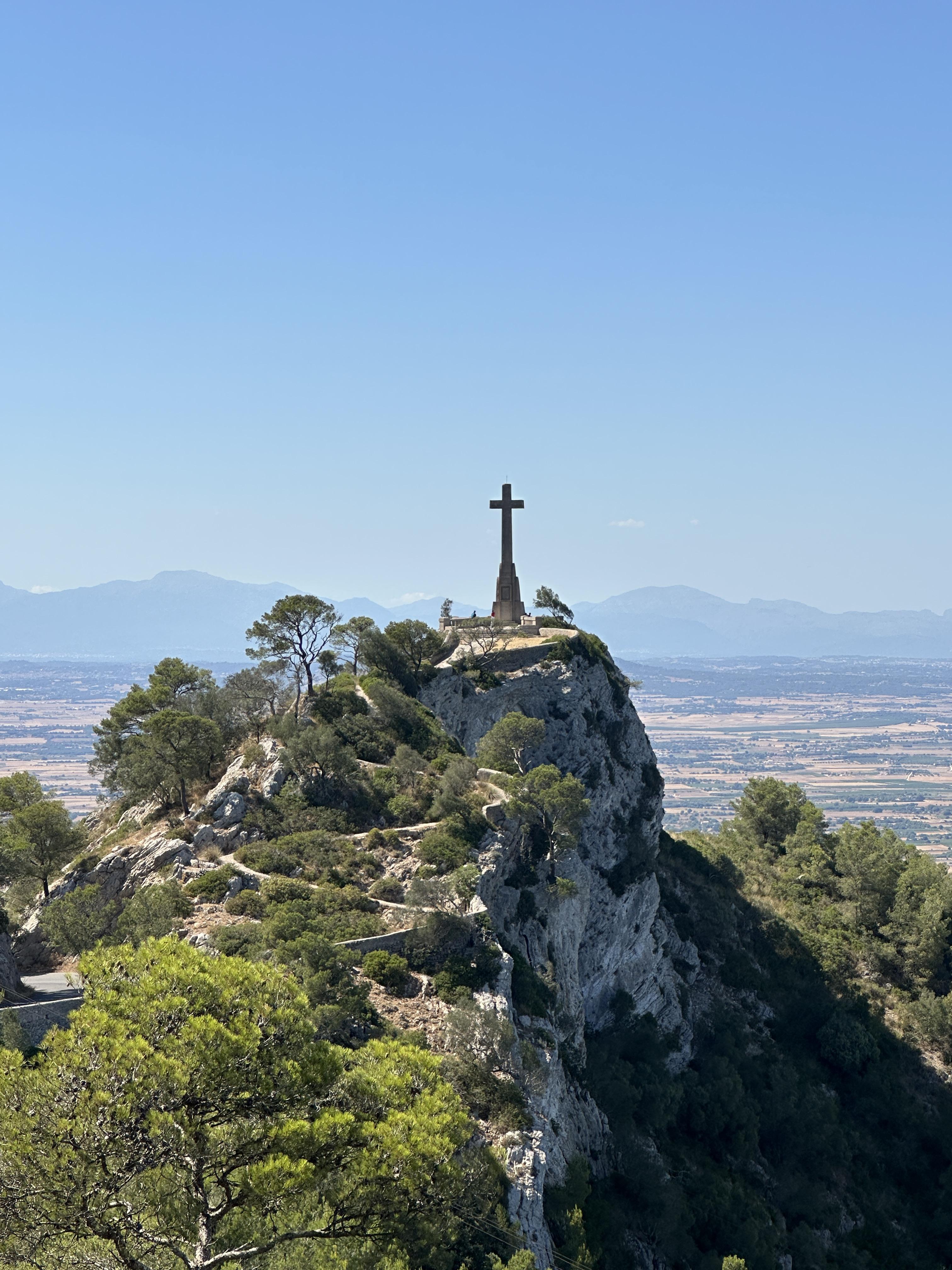 Stone cross on Puig de Sant Salvador overlooking the Mallorcan countryside.